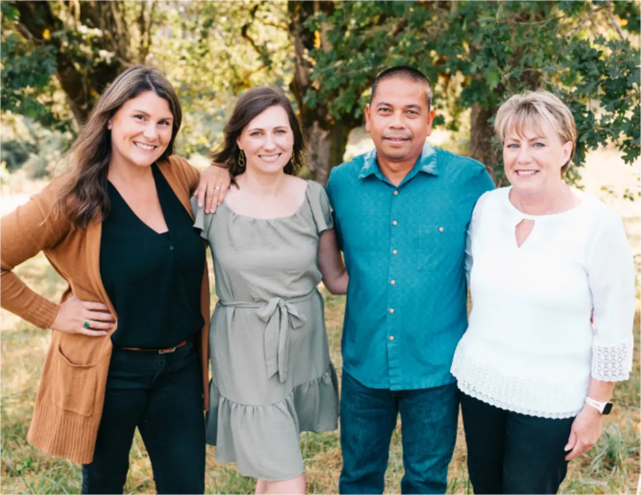 Four members of the Sweet Cheeks Winery team, including winemaker Leo Gabica, standing together under oak trees